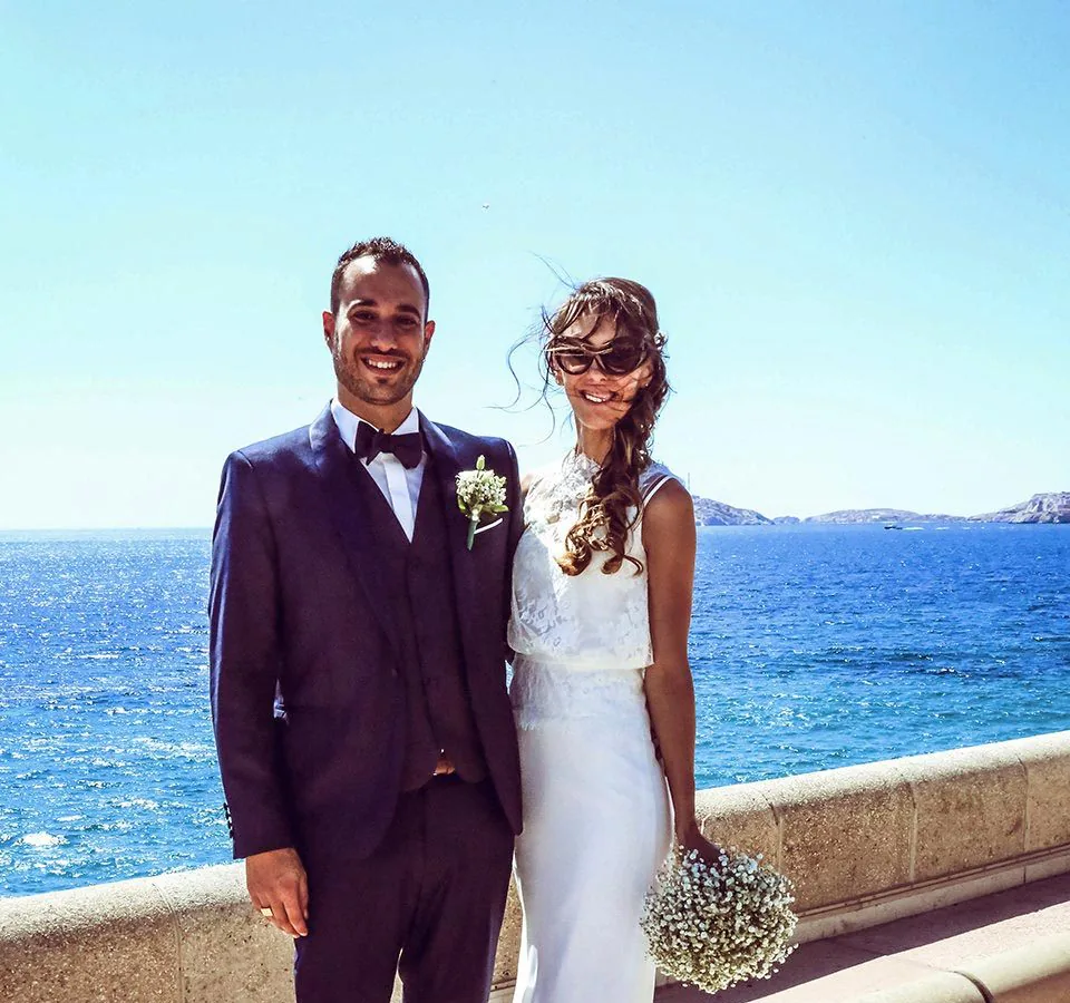Couple de mariés sur la Corniche Kennedy à Marseille, la mer et les îles du Frioul en arrière-plan