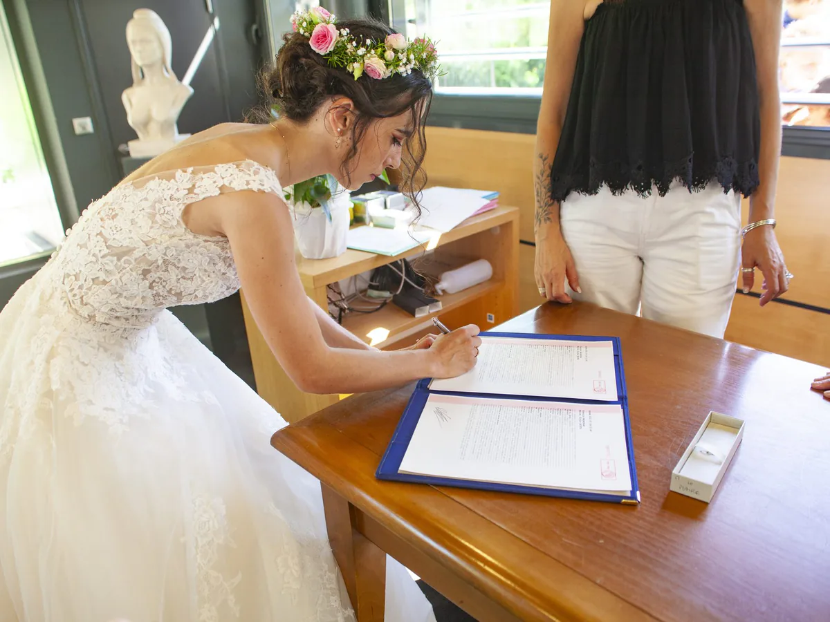 Mariée qui signe le registre à la mairie, lors d’un mariage à Marseille